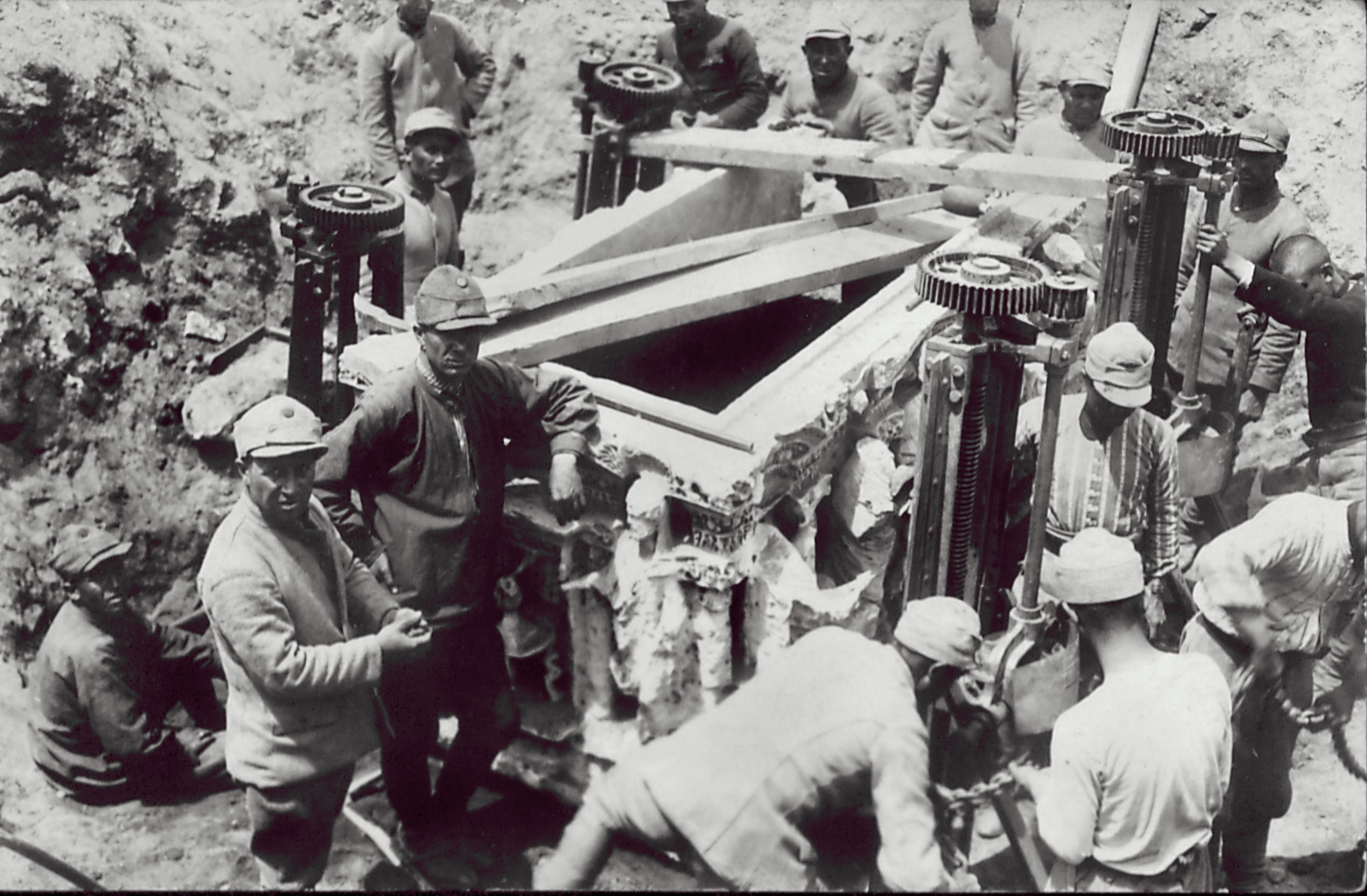 Workers taking out a sarcophagus